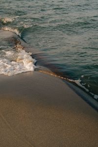 Kaboompics - Wave Breaking on Sandy Beach Shore Close-Up