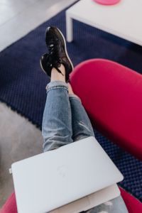 Kaboompics - Woman using laptop computer and sitting cross legs on sofa
