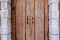 Kaboompics - Weathered Wooden Double Door in a Pale Stone Venetian Facade, Murano Italy