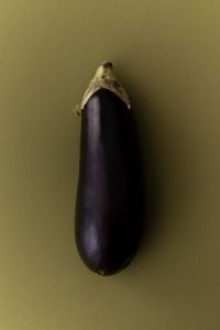Kaboompics - Purple Eggplant on Olive Green Background