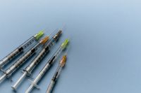 Kaboompics - Colorful Needle Syringes on Blue Background