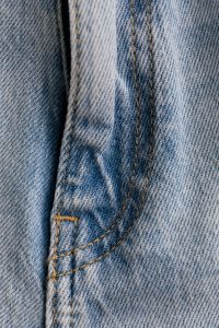 Kaboompics - Close-Up of Curved Back Pocket Stitching and Belt Loop on Light Wash Jeans