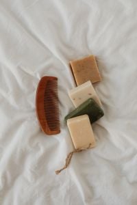 Kaboompics - Wooden Comb and Handmade Soap Bars on White Linen