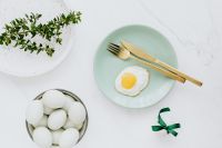 Kaboompics - Easter flat lay with green eggs and fried egg on a plate