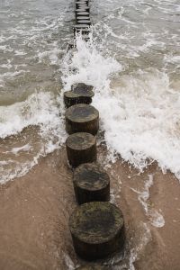 Kaboompics - Breaking Surf Along a Wooden Sea Groyne