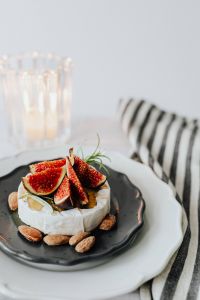 Kaboompics - Vertical Camembert Still Life with Copy Space and Glass Candleholder