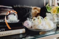 Kaboompics - Soft-Focus Easter Egg Display Under a Glass Cloche on Books in a Cozy Interior