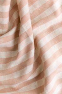 Kaboompics - Minimal striped fabric texture in pastel peach colors