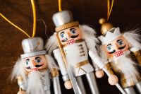Kaboompics - Three Nutcracker Ornaments on Brown Wood