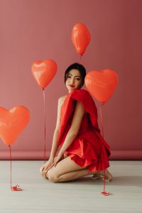 Kaboompics - Valentine’s Day Portrait of Woman in Red Dress With Heart Balloons