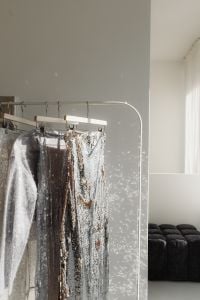 Kaboompics - Glittering Party Dresses on Clothing Rack in Sunlit Room
