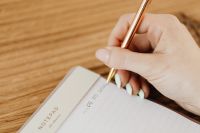 Kaboompics - Detailed View of Gold Pen Writing in Journal