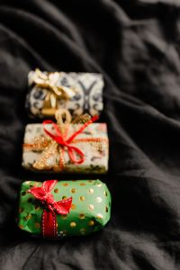 Kaboompics - Stacked Christmas Gifts with Gold and Red Ribbons