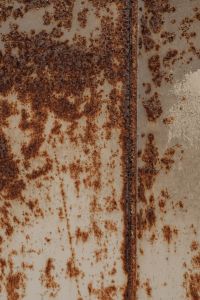 Kaboompics - Rust Spots and Mottled Corrosion on Pale Metal, Industrial Wall Texture Background