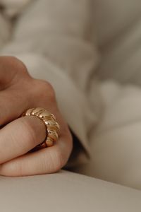 Kaboompics - Chunky Gold Ring Close-Up on Woman's Hand