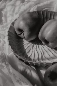 Kaboompics - Black-and-White Close-Up of Green Apples in a Ribbed Ceramic Bowl, Abstract Fruit Texture