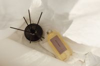 Kaboompics - Overhead Reed Diffuser and Fragrance Oil on White Linen