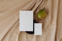 Kaboompics - Minimal Pear and Two Blank Business Cards on Neutral Linen