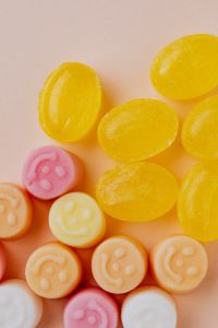 Kaboompics - Yellow Jelly Candies with Pale Beige Copy Space, Minimal Dessert Background