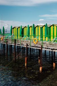 Kaboompics - Green And Yellow Changing Rooms With Umbrellas Over Sorrento Water