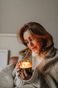 Kaboompics - Stay-at-Home Candlelight: Woman Holding a Jar Candle