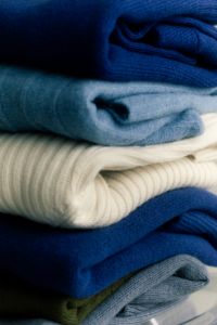 Kaboompics - Stack of Blue and Neutral Sweaters for Winter Capsule Wardrobe