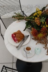 Kaboompics - Coffeehouse Table with Croissant, Espresso and Autumn Bouquet