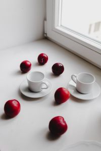 Kaboompics - White Coffee Cups and Red Plums with Copy Space