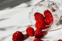 Kaboompics - Raspberries Spilling From Tipped Glass