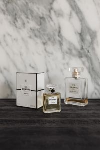 Kaboompics - Three Chanel No. 5 Perfume Bottles and Box on Dark Wood