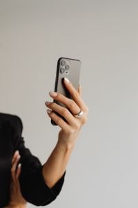 Kaboompics - Woman Holding a Smartphone in a Black Suit