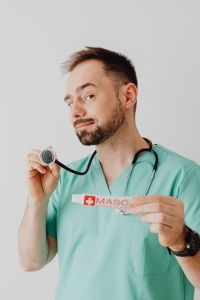 Kaboompics - Doctor Presenting Ointment Tube in Portrait