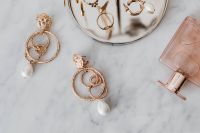 Kaboompics - Gold Hoop and Pearl Drop Earrings beside Pink Perfume on Marble, Close-Up