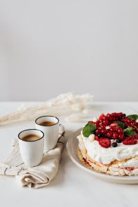 Kaboompics - Vertical Pavlova and Coffee Still Life with Open White Copy Space