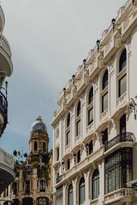 Kaboompics - Vertical Madrid Street View Framed by Historic Facades and a Distant Domed Tower
