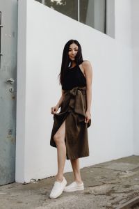 Kaboompics - Asian Fashion Model Holding Brown Wrap Skirt against White Wall and Metal Door