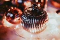 Kaboompics - Close-Up Ribbed Silver Christmas Ornament with Warm Bokeh
