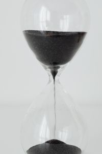 Kaboompics - Macro Detail of Black Sand Inside Clear Hourglass Bulbs and Narrow Glass Neck