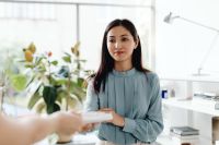 Kaboompics - Asian Woman Discussing Work with a Colleague in a Bright Office