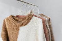 Kaboompics - Close-Up of Sweater Hanging on Wooden Rail