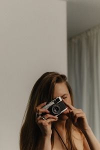 Kaboompics - Woman Taking a Photo with a Compact Camera