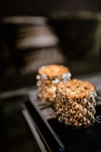 Kaboompics - Gold Glass Candle Holders on a Book Stack with Copy Space