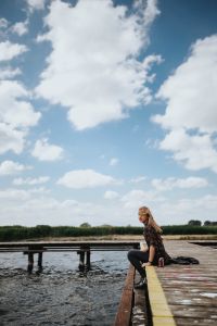 Kaboompics - Beautiful blonde woman on a wooden pier by the lake