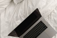 Kaboompics - Laptop on Crumpled White Cotton Bedding, Overhead View