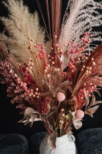 Kaboompics - Colorful Dried Flower Bouquet In Sculptural White Vase On Dark Bench