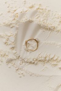 Kaboompics - Delicate Gold Ring on Textured Flour Background