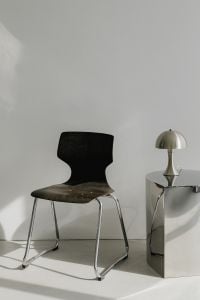 Kaboompics - Black Chrome-Frame Chair Beside Chrome Pedestal and Dome Lamp