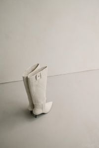Kaboompics - White Pointed Knee-High Boots on Minimal Pedestal