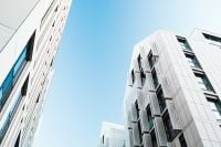 Kaboompics - Low-Angle View of Modern White Office Buildings in Gdańsk Against Blue Sky