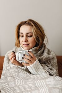 Kaboompics - Woman Taking a Quiet Tea Break Wrapped in a Blanket